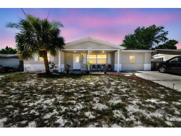 Charming single-story home with a well-maintained yard and inviting curb appeal in a quiet neighborhood at 7535 Christina Ln, Port Richey, FL 34668