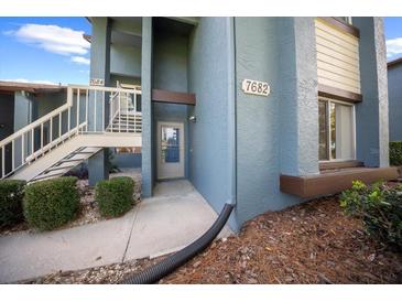 Inviting condo featuring a blue exterior with a well-maintained landscape at 7682 St Andrews Blvd, Weeki Wachee, FL 34613