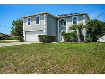 Charming two-story home featuring a well-manicured lawn and attached two-car garage at 8388 Maltby Rd, Spring Hill, FL 34606
