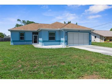 Charming blue single-story home featuring a well-manicured lawn and a two-car garage at 9251 Geneva St, Spring Hill, FL 34608