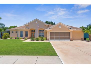 Charming single-story home featuring a well-maintained lawn and a spacious two-car garage at 13155 Cori Loop, Spring Hill, FL 34609