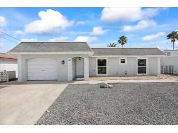 Charming single-Gathering home featuring an attached garage and a manicured front yard at 3907 Headsail Dr, New Port Richey, FL 34652