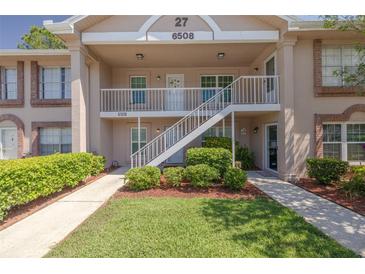 Charming two-story condo with well-maintained landscaping and inviting walkways at 6508 Tina Dr # 14, New Port Richey, FL 34653
