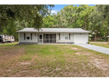Charming one-story home with a well-manicured lawn and a gray exterior at 7340 20Th, Zephyrhills, FL 33540