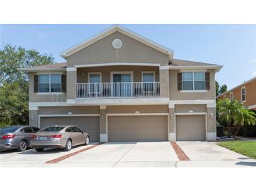 Inviting townhouse featuring a private balcony and attached garages, set in a well-maintained community at 8409 Blue Rock Dr, New Port Richey, FL 34653