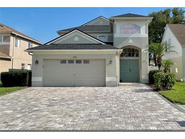 Charming two-story home with a well-manicured front yard and a beautiful paver driveway at 9808 Riverchase Dr, New Port Richey, FL 34655