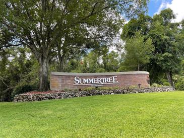 Welcome to Summertree, a lovely community sign surrounded by beautiful, mature trees and manicured landscaping at 11619 Boynton Ln, New Port Richey, FL 34654