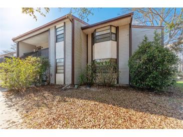 Charming two-story townhouse featuring neutral siding and well-maintained landscaping at 12155 Environmental Dr # 8, New Port Richey, FL 34654