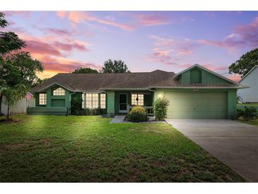 Charming single-story home with lush lawn, mature trees, and attached two-car garage at 3468 El Prado Ave, Spring Hill, FL 34609