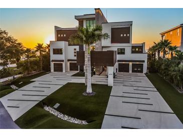 Stunning modern home boasting meticulous landscaping, multi-car garage, and distinctive architectural details at 4333 Harborpointe Dr, Port Richey, FL 34668
