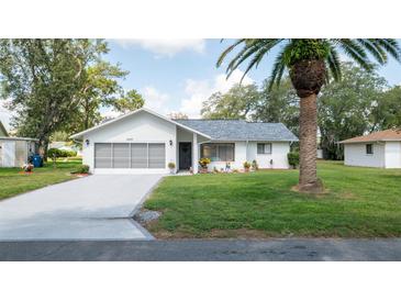 Charming single-story home with a well-maintained lawn, mature trees, and an attached two-car garage at 5309 Bayonne Ave, Spring Hill, FL 34608