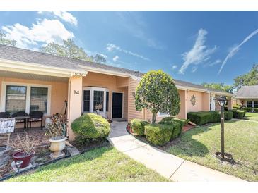 Charming single-story villa with well-maintained landscaping, walkway, and inviting entrance at 9334 Whitstone Ct, New Port Richey, FL 34655