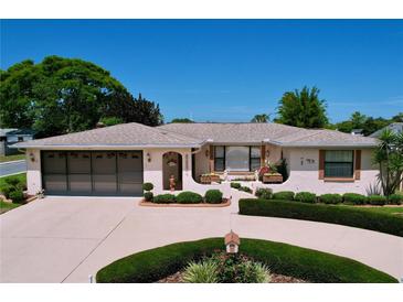 Charming single-story home featuring a well-manicured front yard and attached two-car garage at 10111 Glen Moor Ln, Port Richey, FL 34668