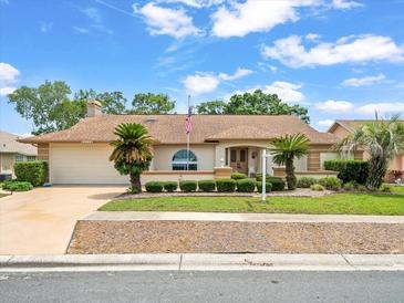 Charming single-story home featuring a well-manicured lawn and an attached two-car garage at 10442 Ventura Dr, Spring Hill, FL 34608