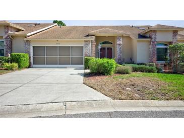 Charming villa with a screen enclosed garage and landscaped front yard, ready for a new owner! at 2348 Rolling View Dr, Spring Hill, FL 34606