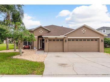 Charming single-story home with a well-manicured lawn and a two-car garage at 2526 Brinley Dr, Trinity, FL 34655