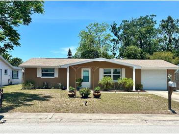 Charming single-story home with a well-maintained front yard and classic curb appeal at 7861 Raintree Dr, New Port Richey, FL 34653