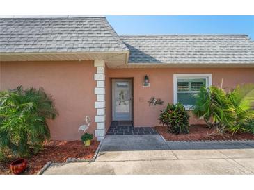 Charming home entrance with decorative features and well-maintained landscaping at 9622 Brassie Ct # 9, New Port Richey, FL 34655