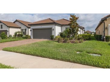 Charming single-story home with well-manicured lawn and a two car garage with a beautiful tile roof at 3051 Francoa Dr, Odessa, FL 33556