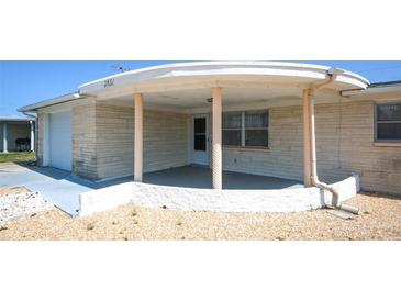 Charming home featuring a covered front porch with support columns and neutral exterior at 3851 Redwood Dr, Holiday, FL 34691