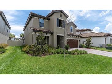 Beautiful two story home with a well-manicured lawn, stylish landscaping, and a tile roof at 4056 Burdick Loop, Odessa, FL 33556
