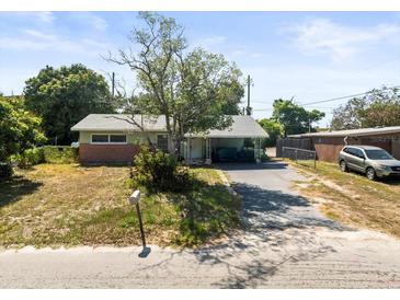 Single story home featuring a carport and mature landscaping at 5121 Hemlock Dr, New Port Richey, FL 34652