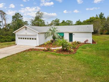 Charming single-story home with well-maintained landscaping and a white exterior at 6197 Belkton Ave, Spring Hill, FL 34608