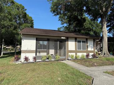 Inviting single-story home featuring fresh landscaping and a screened porch at 2270 Alden Ln # A, Palm Harbor, FL 34683