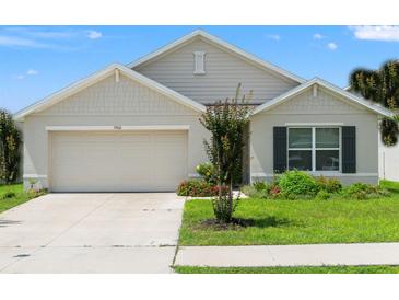 Charming one-story home with a well-maintained lawn and inviting two-car garage, providing curb appeal at 3900 Autumn Amber Dr, Spring Hill, FL 34609