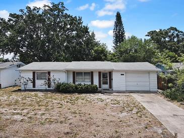 Charming single-story home with a well-maintained exterior, classic shutters, and a one car attached garage at 4388 Craftsbury Dr, New Port Richey, FL 34652