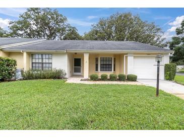 Charming single-story home with well-manicured lawn and inviting front entrance with brick accents and an attached garage at 4841 Wakefield Ct # 4841, New Port Richey, FL 34655