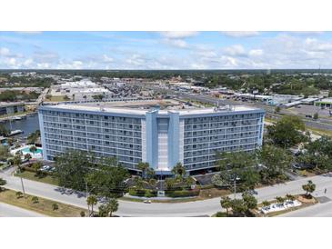 Stunning condo building featuring waterfront views, a circular drive and lush landscaping at 4939 Floramar Ter # 611, New Port Richey, FL 34652