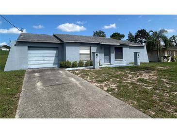 Charming single-story home with an attached garage and well-lit walkway at 5391 Pillar Ave, Spring Hill, FL 34608