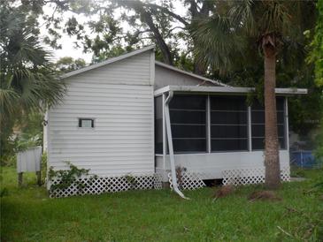 A quaint one-story home boasts a screened lanai and mature landscaping at 5625 Van Doren Ave, New Port Richey, FL 34652