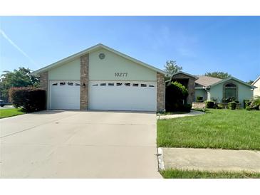 Charming single-story home featuring a two-car garage and a well-manicured lawn at 10277 Rosetti Ct, Spring Hill, FL 34608