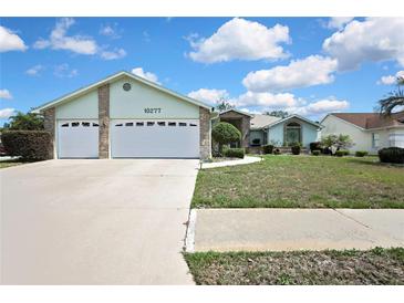 Charming single-story home features a well-maintained lawn, two-car garage, and inviting front entrance at 10277 Rosetti Ct, Spring Hill, FL 34608