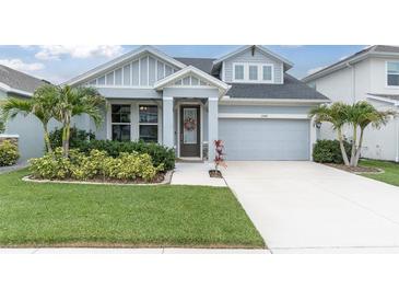 Charming single-Gathering home with a well-manicured lawn and inviting front entrance with beautiful landscaping at 15241 Caravan Ave, Odessa, FL 33556