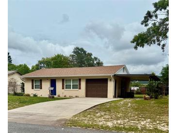 Charming single-story home featuring a well-maintained yard, covered parking and a freshly painted exterior at 2234 Marietta Ave, Spring Hill, FL 34608