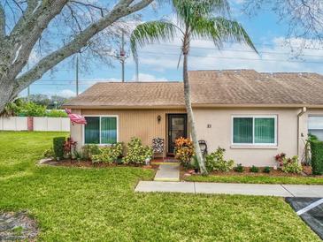 Charming single-story home with well-maintained landscaping and inviting front entrance at 3832 Sailmaker Ln # 3832, Holiday, FL 34691