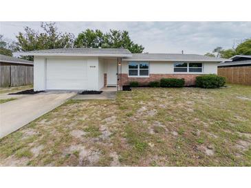 Charming single-story home with brick accents, updated windows, and a one car garage at 7608 Bougenville Dr, Port Richey, FL 34668