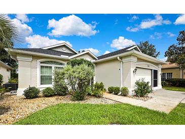 Charming single-story home showcasing manicured landscaping and a welcoming front entrance on a sunny day at 10093 Holly Berry Dr, Weeki Wachee, FL 34613