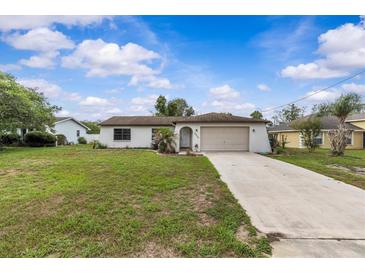 Charming single-story home featuring a well-maintained lawn and attached garage at 2450 Ambassador Ave, Spring Hill, FL 34609