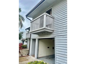 Exterior view of home featuring a garage and balcony at 6462 92Nd N Pl # 806, Pinellas Park, FL 33782