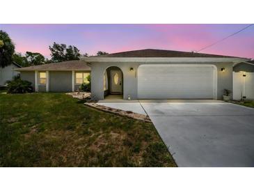 Charming single-story home featuring a welcoming arched entryway and an attached two-car garage at 11280 Sedgefield Ave, Spring Hill, FL 34608