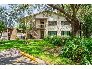 Charming condo with lush landscaping and a well-maintained lawn, inviting visitors into the property at 13009 Wedgewood Way # 63-D, Hudson, FL 34667