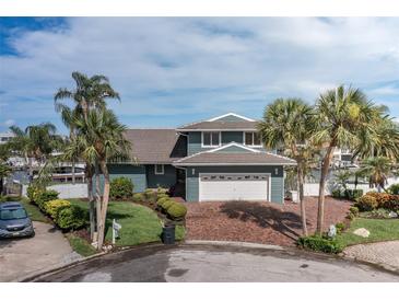 Beautiful two-story home featuring a brick driveway, lush landscaping, and a two-car garage at 3150 Trident Ter, New Port Richey, FL 34652