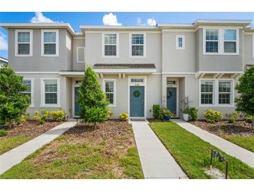 Charming townhome with neutral exterior, well-maintained landscaping, and inviting blue front door with wreath at 6240 Fairmont Ln, Palmetto, FL 34221