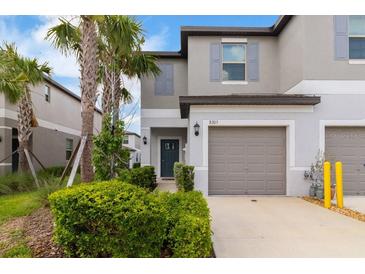 Charming townhome with a well-maintained front yard and a one car garage at 8305 Crescent Oaks Dr, New Port Richey, FL 34655