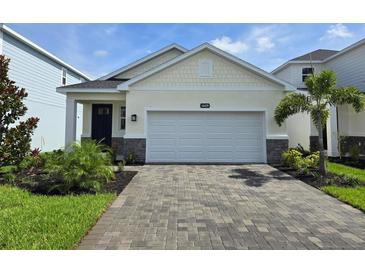 Charming single-Gathering home boasts a two-car garage and brick-paved driveway at 14429 Maiden Ter, Lakewood Ranch, FL 34211