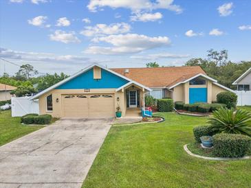 Charming single-Gathering home featuring well-maintained landscaping, a two-car garage, and a welcoming entrance at 14646 Coronado Dr, Spring Hill, FL 34609